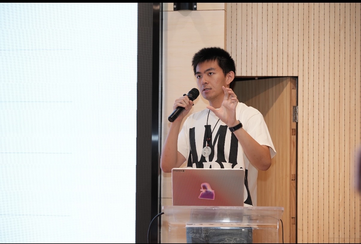 Leon Liu speaking into a microphone at Open AGI Builders Day in Shanghai