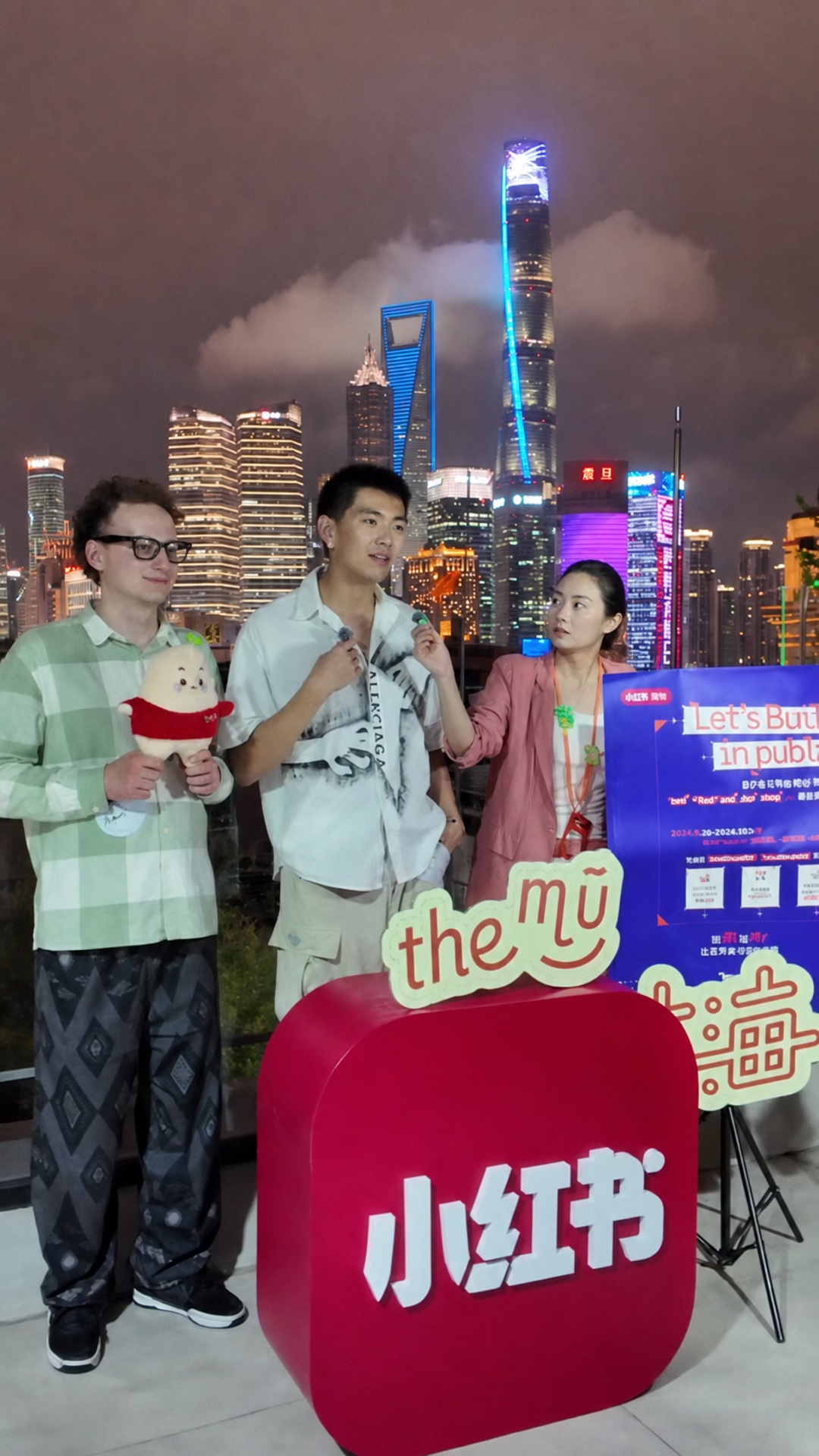 Leon Liu being interviewed with RedNote and MU Shanghai against the Shanghai skyline